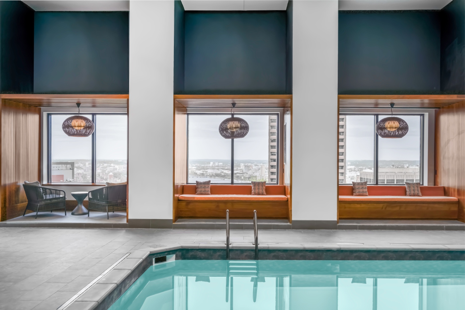Benches by indoor pool window.