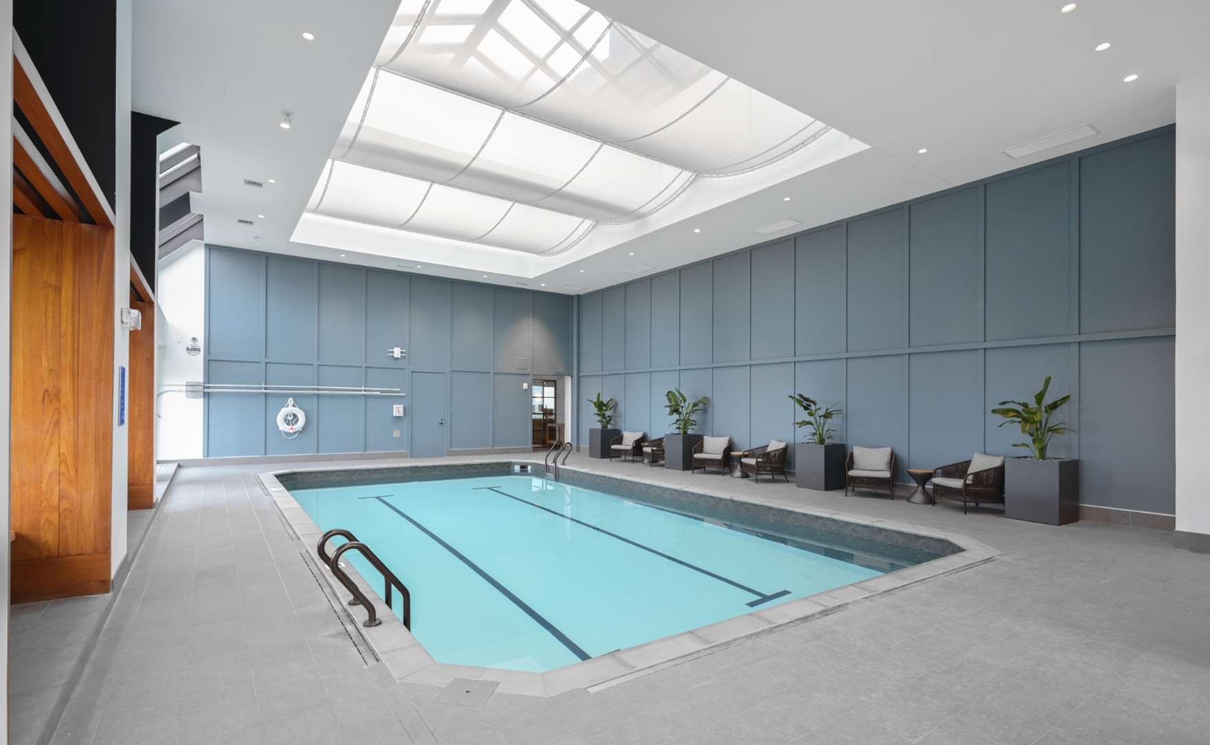 Alternate angle of indoor pool with seating.