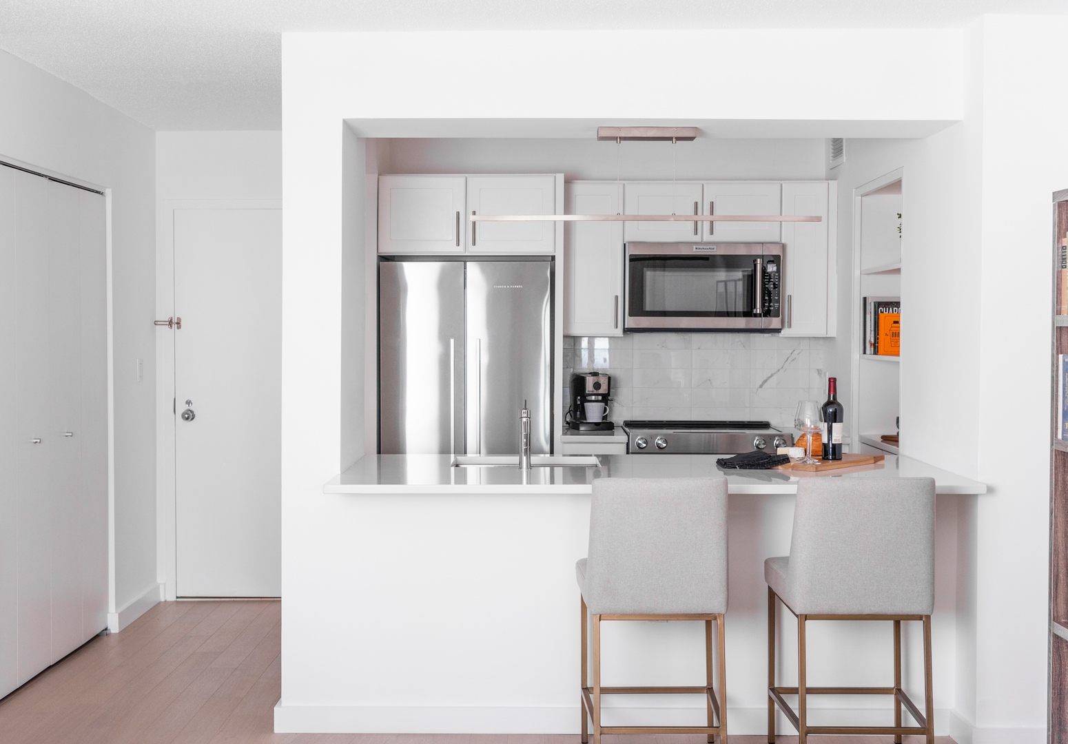 One bedroom kitchen with window counter and barstools.