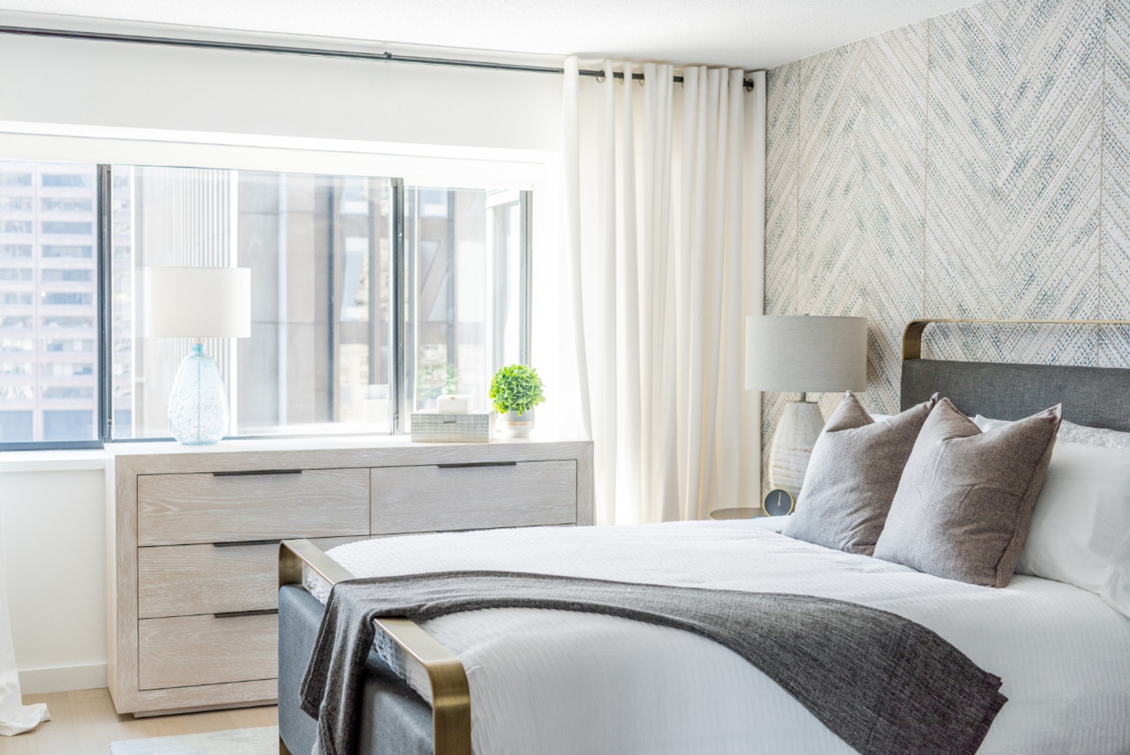 Close-up of bedroom with window view.
