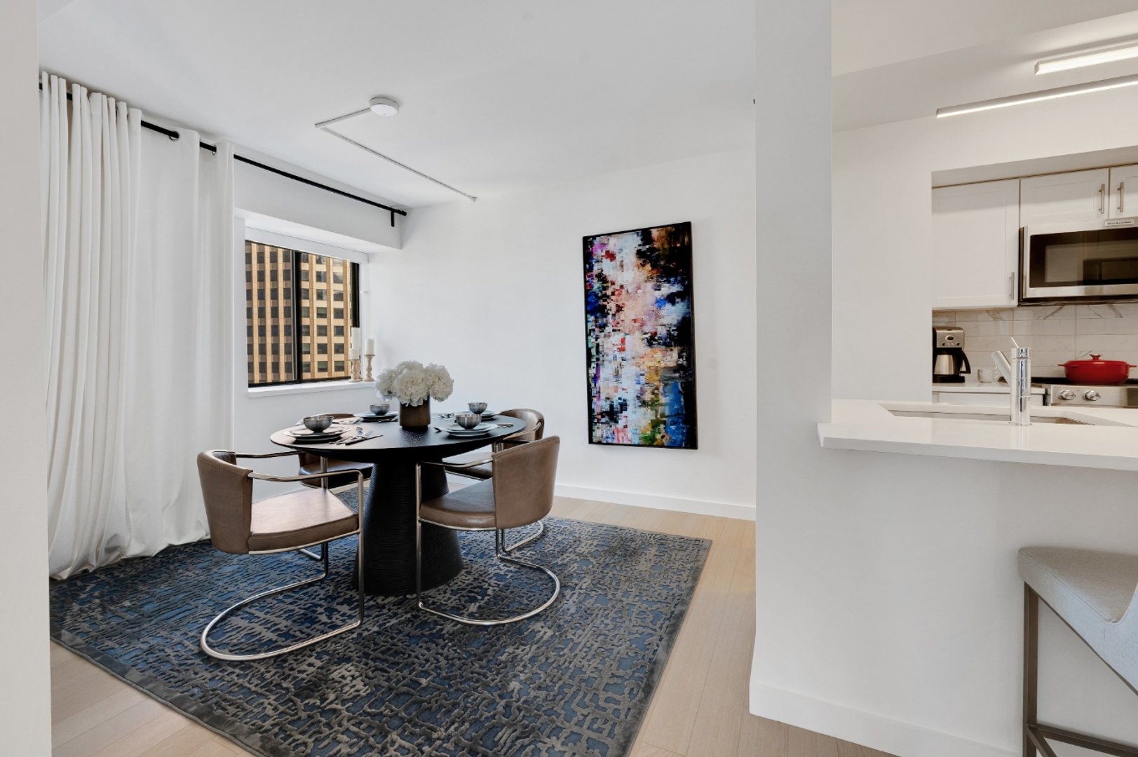 Two bedroom kitchen and dining area with windows.