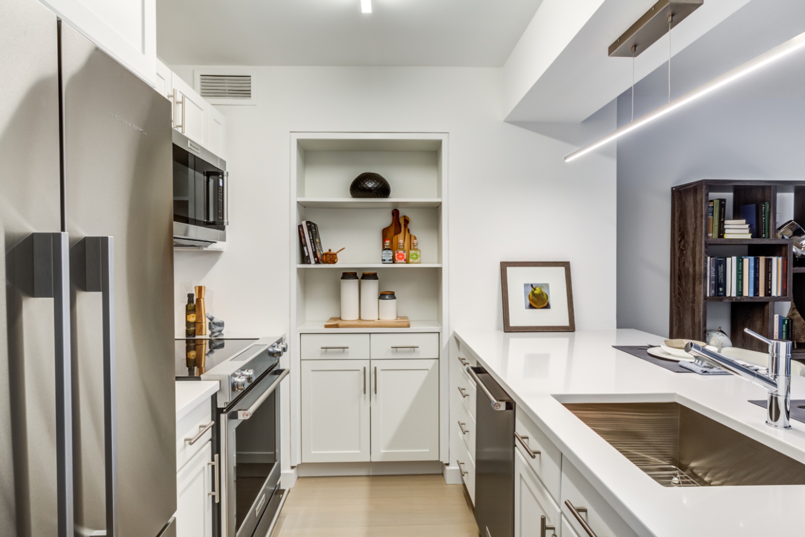 Two bedroom kitchen with appliances and counter.