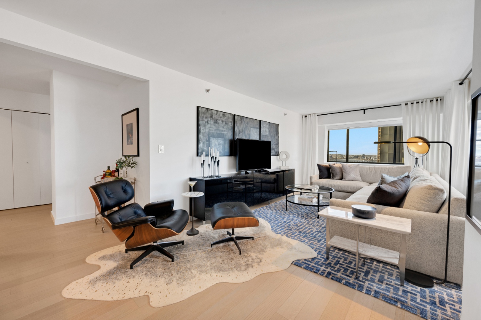 Two bedroom living room with windows.